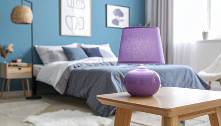 Purple lamp on table in modern bedroom, closeup. Interior designの素材