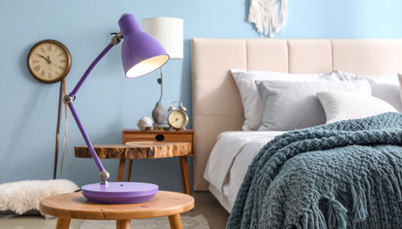 Purple lamp on wooden table in bedroom. Stylish interior designの素材