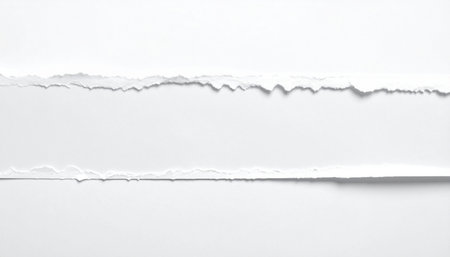 A horizontal strip of torn white paper with jagged edges creates a blank space on a white background.の素材