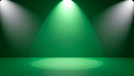 An empty green studio space with three bright spotlights casting dramatic beams of light.の素材