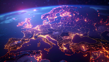 A detailed view of Europe at night from space, with cities emitting a warm orange glow against the deep blue of the...の素材
