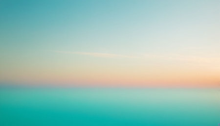 Hues showing calm sea horizon at dawn with faint clouds and a gradient sky of teal orange and pink hues.の素材