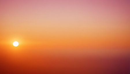 A soft gradient of pink and orange fills the sky, with a small, bright white sun disc positioned on the left.の素材