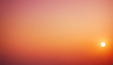 A soft gradient of pink, orange, and red fills the frame with a small white sun on the right.の素材
