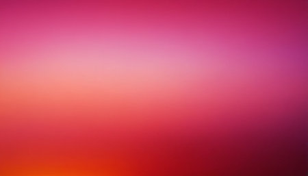 A soft gradient blends deep pink and red hues, featuring a bright luminous center and subtle hints of orange at the...の素材