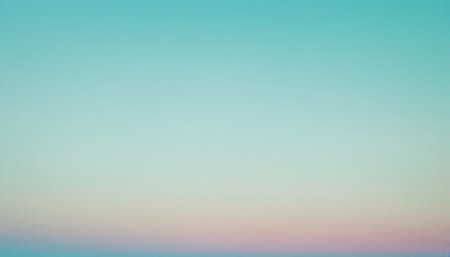 A soft pastel gradient sky with hues of pale blue, peach, and pink blending at the horizon.の素材