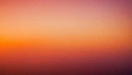 A smooth gradient transitions from vibrant orange and pink at the to deep red and purple at the bottom.の素材