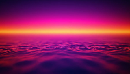 With showing vibrant neon sunset over abstract digital ocean waves with purple pink orange gradient sky.の素材