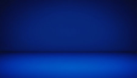 An empty studio space with deep blue walls and floor, illuminated by a soft spotlight effect creating a gradient.の素材