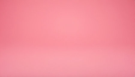 A soft pink studio backdrop with a subtle gradient, appearing as a seamless floor and wall transition for placement.の素材