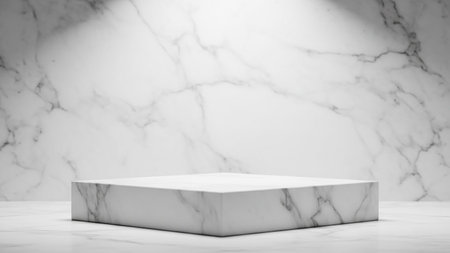 A white marble square pedestal sits on a marble surface, illuminated by soft light against a textured marble wall.の素材