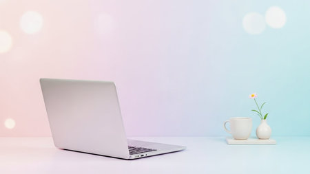 Small showing modern silver laptop open on a desk with a small white vase and cup of coffee. resolutionの素材