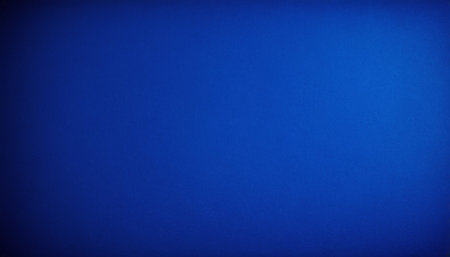 Light showing rich deep blue textured background with subtle light variations and a soft vignette effect.の素材