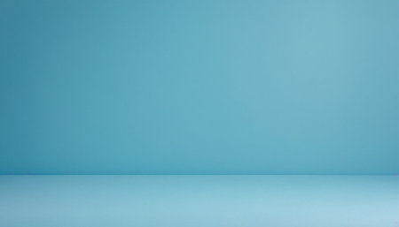 A seamless light blue studio backdrop meets a slightly lighter blue floor, forming a clean, minimalist corner.の素材