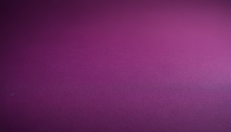 A smooth plum purple background featuring a subtle light gradient effect originating from the right corner.の素材