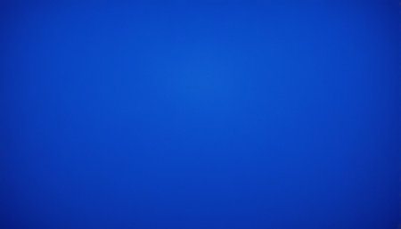 A solid deep blue gradient background with a soft vignette and a gentle light transition that subtly illuminates the...の素材