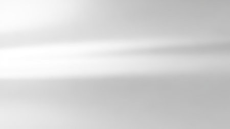 A soft, diffused light creates a subtle horizontal gradient across a clean, minimalist grey and white background.の素材