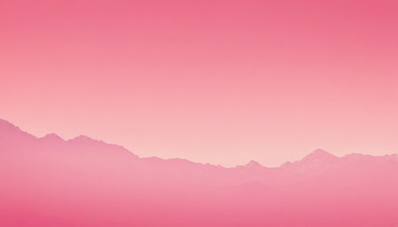 A silhouette of a mountain range in shades of pink is set against a soft pink and peach gradient sky, suggesting...の素材