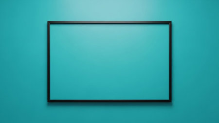 A black rectangular frame is centered on a solid teal blue wall with soft lighting creating a clean and minimalist...の素材