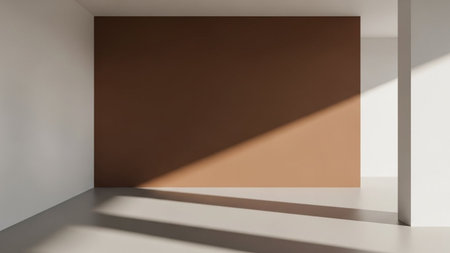 A minimalist interior space with contrasting brown and white walls, featuring strong diagonal sunlight casting...の素材