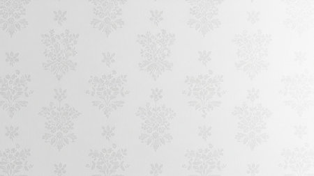 A subtle white floral damask pattern repeats across a light grey textured background, creating a delicate and...の写真素材