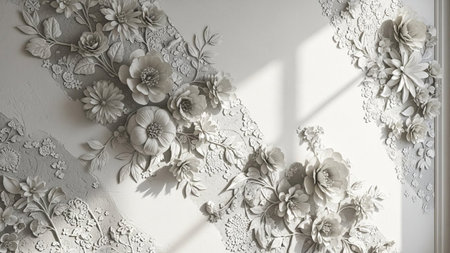 A detailed white floral relief sculpture with intricate flowers and leaves adorns a textured wall, casting shadows...の写真素材