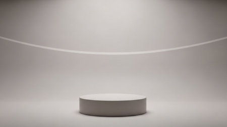 A simple grey cylindrical podium sits on a seamless studio floor, illuminated by soft spotlights with a subtle...の写真素材