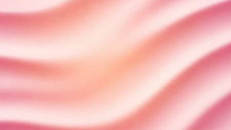 A soft focus background with smooth, flowing waves of pastel pink and peach colors creating a gentle, luminous...の写真素材