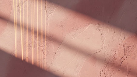 With showing textured pink wall with warm sunlight streaks and shadow lines. resolutionの写真素材