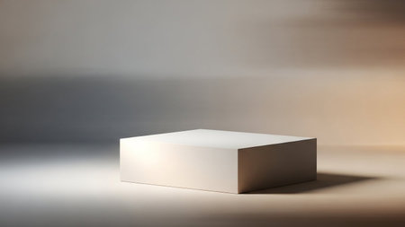 A simple beige cube pedestal sits on a light gray surface, illuminated by soft, diffused studio...
