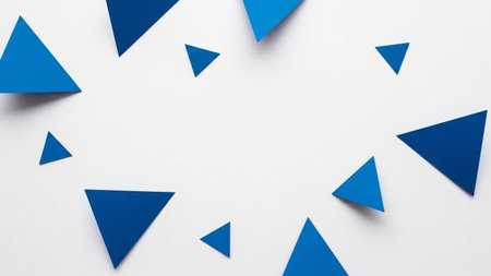Various sizes of sharp blue geometric triangles are scattered across a clean, bright white background.の素材