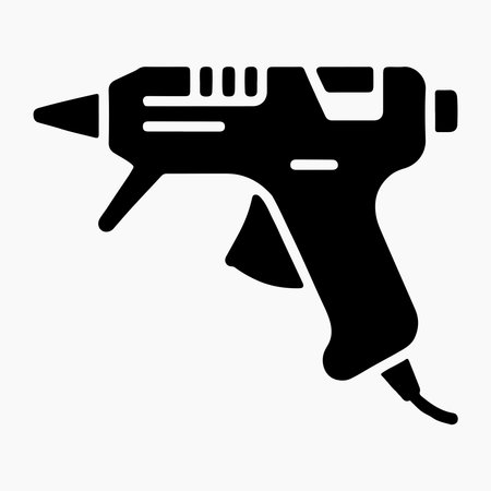 A clean, solid icon representing a glue gun, presented in isolation on a white background for versatile design applications.のイラスト素材
