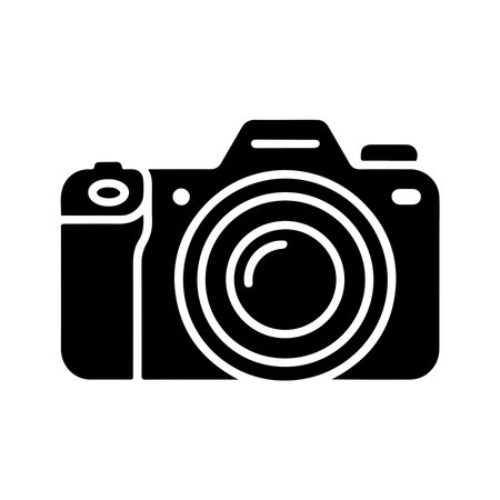 A clean, solid icon representing a DSLR camera, presented in isolation on a white background for versatile use.のイラスト素材