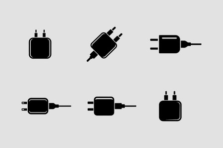 A collection of solid icons representing charging adapters, presented as an isolated object on a clean white background.のイラスト素材