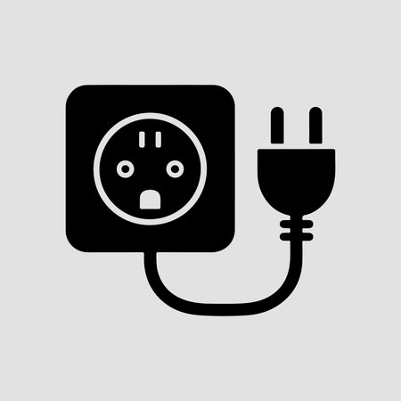 A clean, solid icon representing an electrical plug socket connected to a cable, presented in isolation on a white background.のイラスト素材