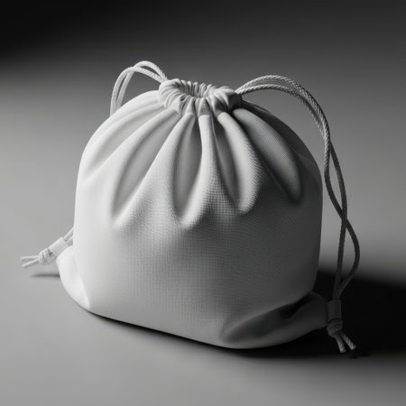 This image showcases a supple leather drawstring pouch, cinched closed with its cord. The object is presented clearly isolated on a white background, highlighting its texture and form.の素材