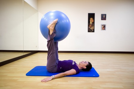 Woman exercising with a fitness ballの写真素材