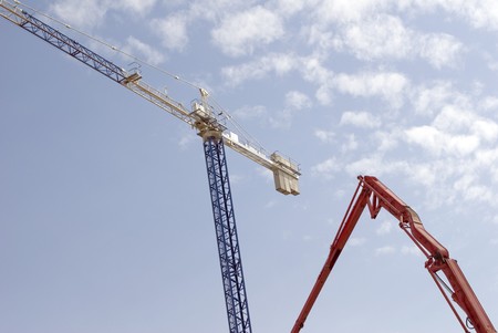 Low angle view of cranes at a construction siteの写真素材