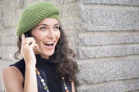 Happy and smiling young latin woman talking on the mobile phone.の写真素材