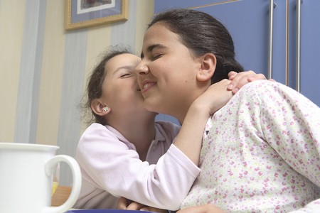 Sisters kissing each other.の写真素材