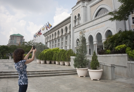 Tourist woman taking picture of Palace of Justice, Istana Kehakiman, Putrajaya, Malaysiaのeditorial素材