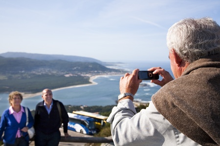 August, 2009. Senior tourist taking pictures of the mouth of Miï¿½o River, from the viewpoint of Santa Tecla, La Guardia, Galicia, Spain.のeditorial素材