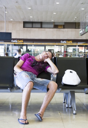 July 2010, Barcelona, Sants train station. Young man sleeping at train station.のeditorial素材