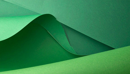 close up of green origami paper background with soft light and shadowの素材