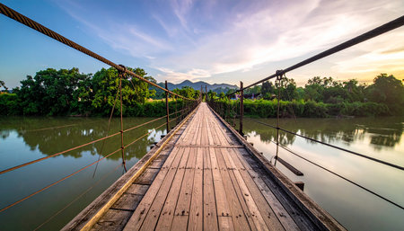 Old wooden bridge over the river at sunset in Sangkhlaburi, Kanchanaburi, Thailandの素材
