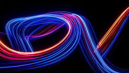 Colorful light trails on the black background. Long exposure photo.の素材