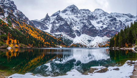 Mountain lake in autumn with snow and reflection of the mountains.の素材