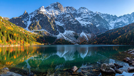 Autumn alpine lake with reflection of snow-capped mountainsの素材