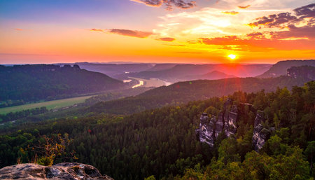 Sunset over misty valley in Saxony Switzerland National Park.の素材