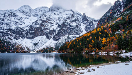 Landscape of autumn alpine lake and snow covered mountains. Italyの素材